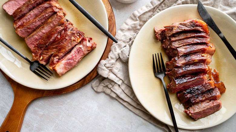 sliced seared steaks on plates