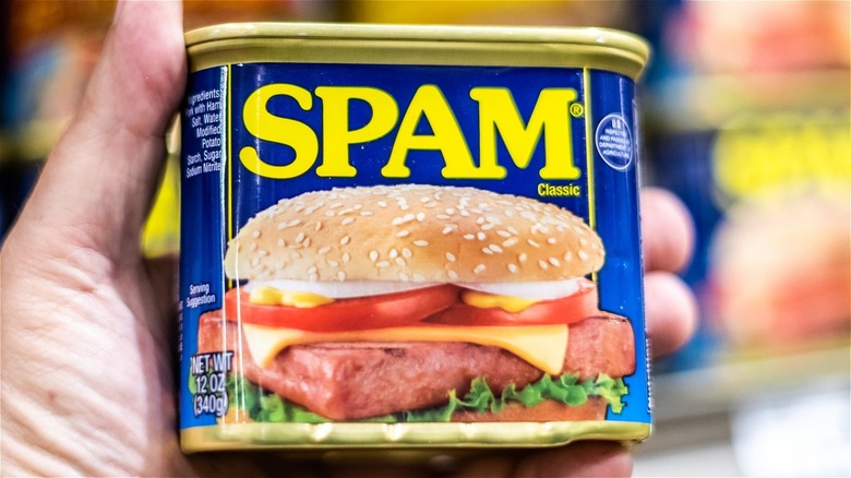 hand holding a can of Spam