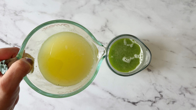 Lime juice pouring into pitcher with green liquid