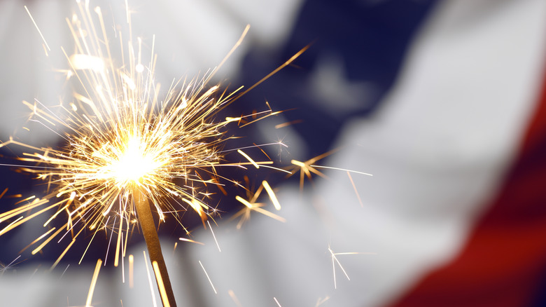 a sparkler in front of an American flag
