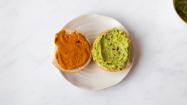bun halves spread with guacamole and chipotle mayonnaise