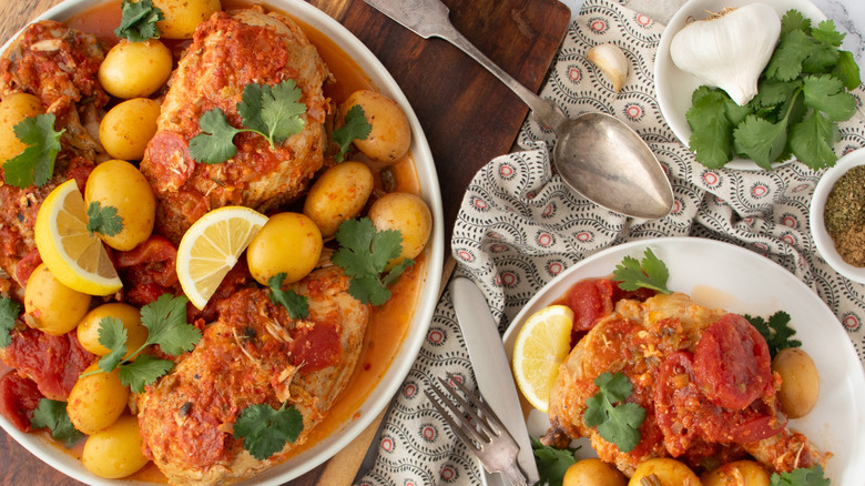 chicken with tomato chile piri piri sauce on plates with potatoes