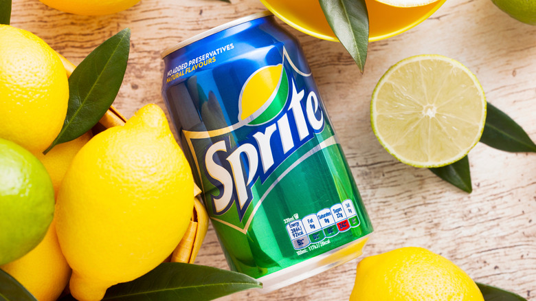 Can of Sprite surrounded by fresh lemons and limes