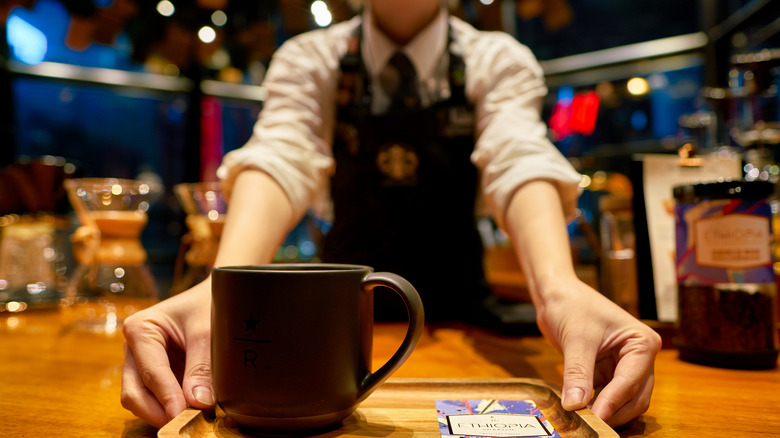 Barista serving drink