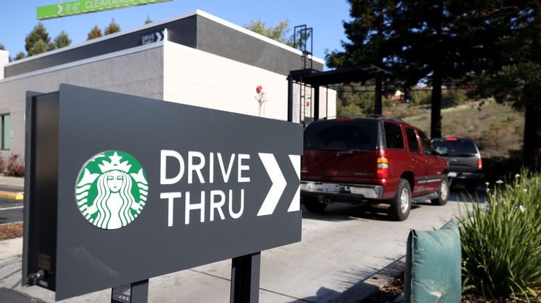 Sign pointing to Starbucks drive thru