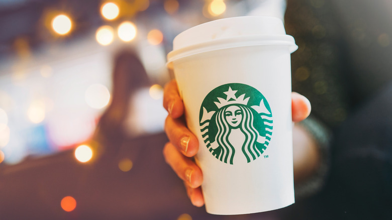 hand holding starbucks cup