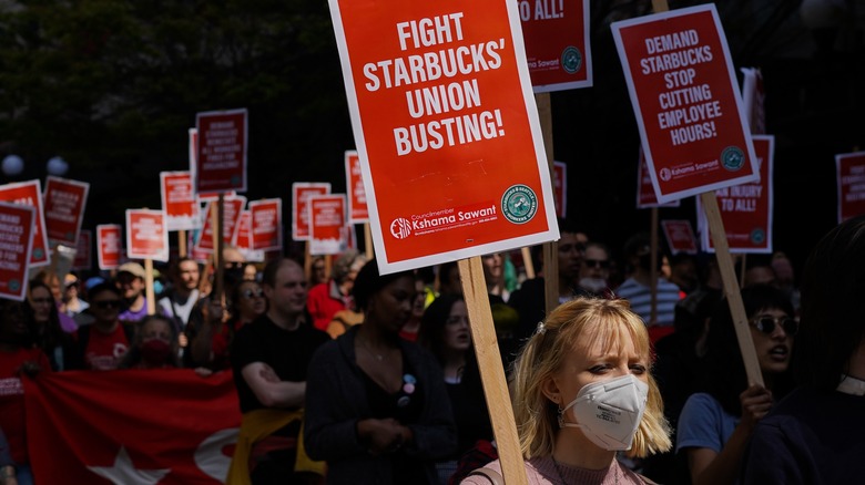 Girl holding red picket sign