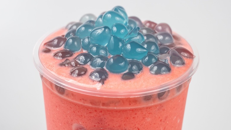 Blue boba pearls in pink beverage