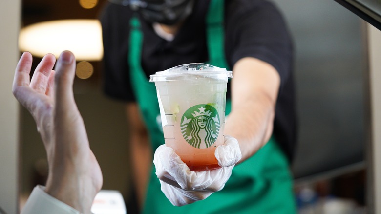 grabbing lemonade from Starbucks window