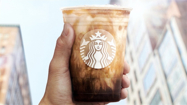 hand holding Starbucks drink