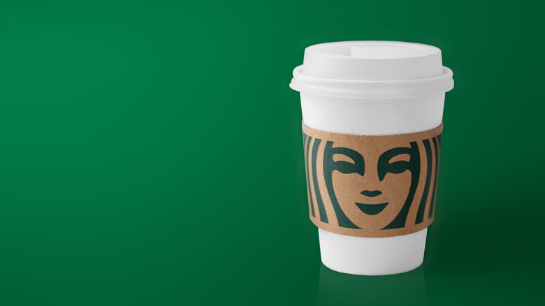 Starbucks cup on green background