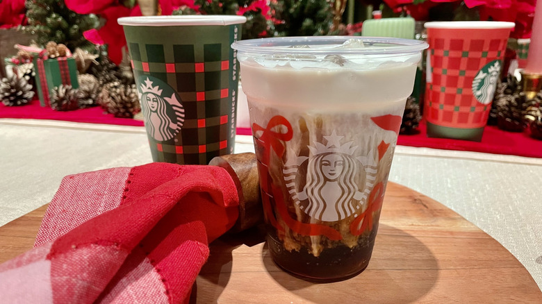 A cup of the new Eggnog Cold Foam Cold Brew on the Starbucks Holiday Menu