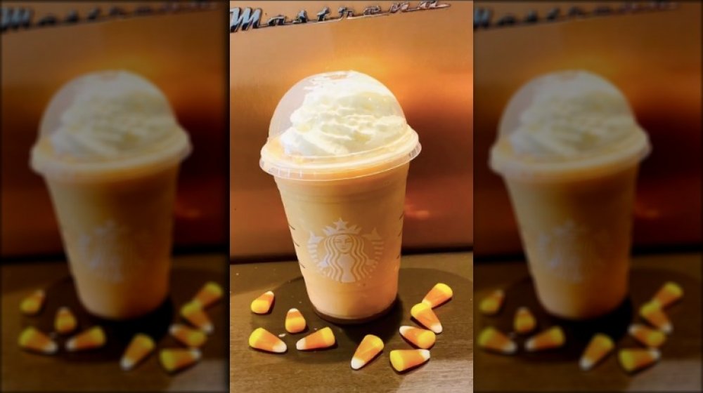 candy corn frappuccino surrounded by candy corn