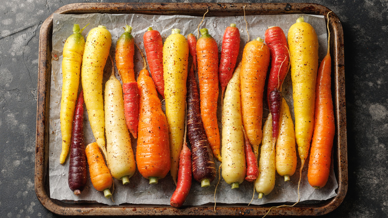 colorful carrots on a baking sheet