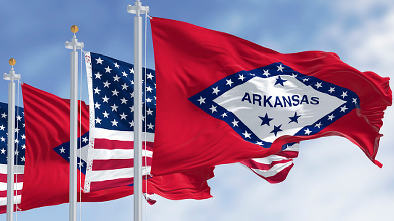 Arkansas state flag flying with American flag