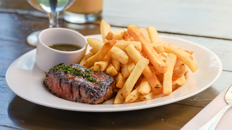 plate of steak with fries