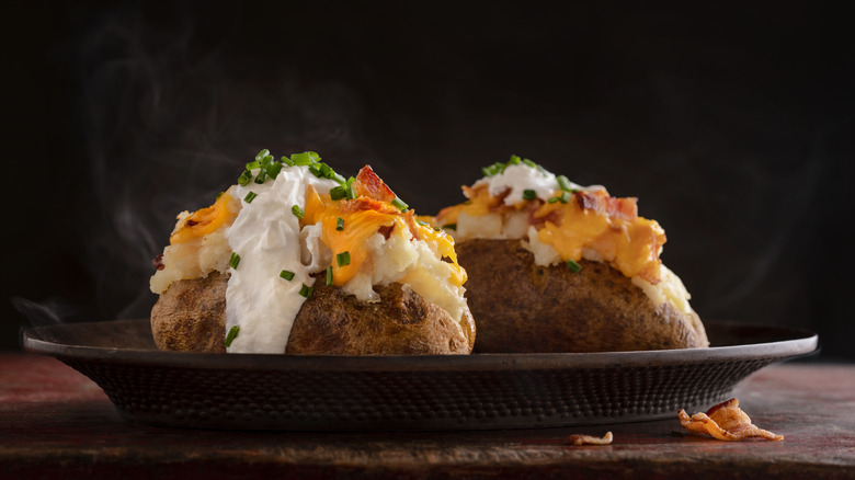 Loaded baked potatoes on plate