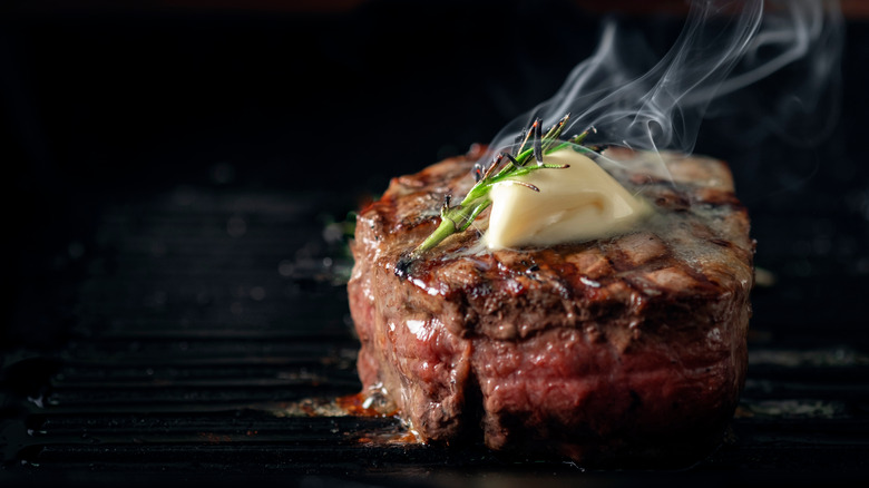 Beef tenderloin topped with butter and rosemary