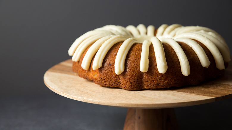 iced carrot cake on stand