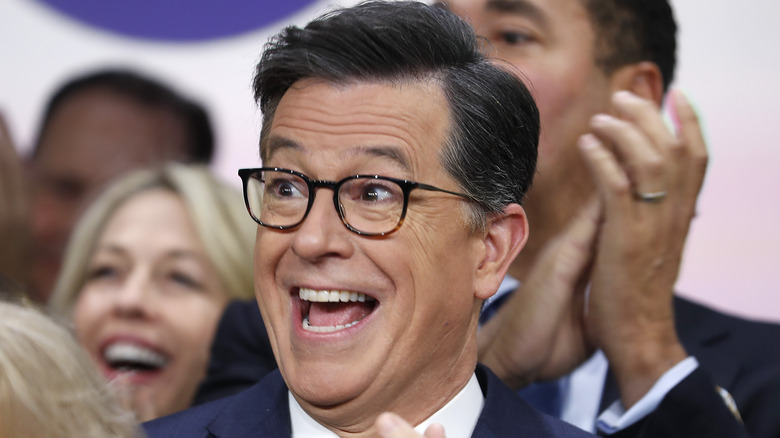 Stephen Colbert laughing in glasses