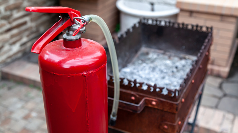 Fire extinguisher next to a barbecue pit