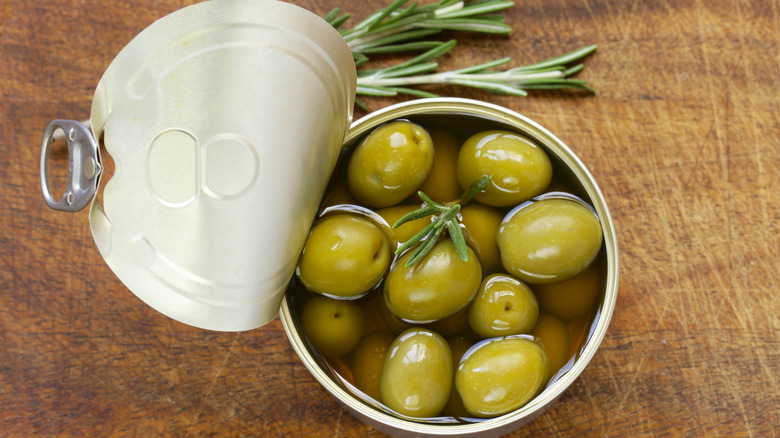 open can of green olives