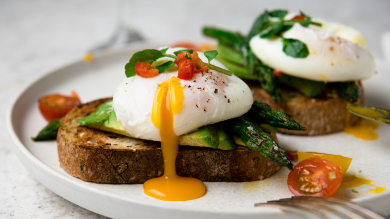 Runny poached egg on toast