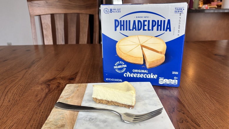 cheesecake on plate with fork and cheesecake box