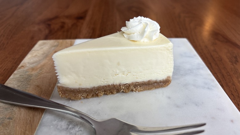 cheesecake with swirl of whipped cream on top