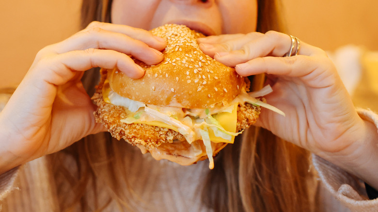 woman eating chicken sandwich 