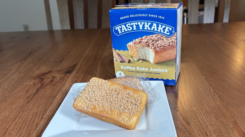 Two Tastykake coffee cakes on plate in front of box