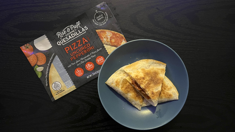 Sliced pizza quesadilla in blue bowl with packaging