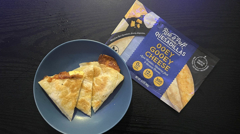 Sliced cheese quesadilla in blue bowl with packaging