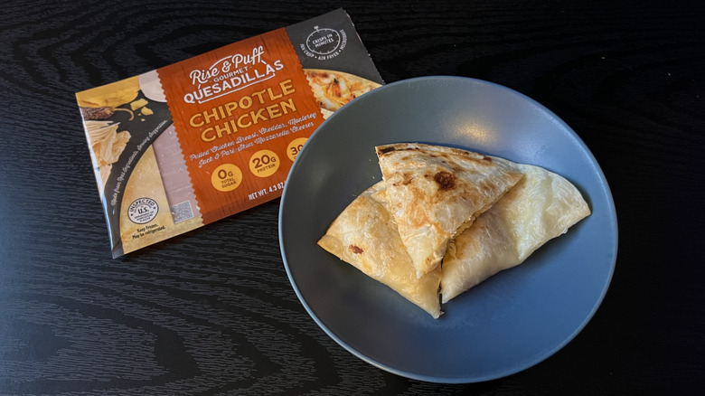 Sliced chipotle chicken quesadilla in blue bowl with packaging