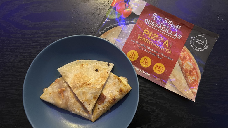 Sliced pizza margherita quesadilla in blue bowl with packaging