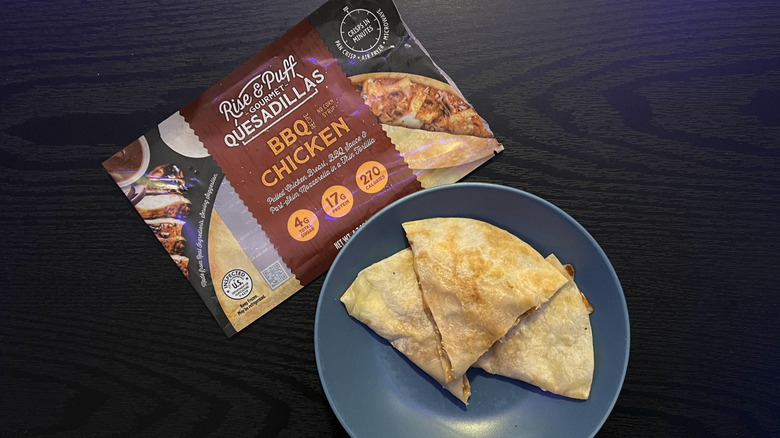 Sliced BBQ chicken qeusadilla in blue bowl with packaging