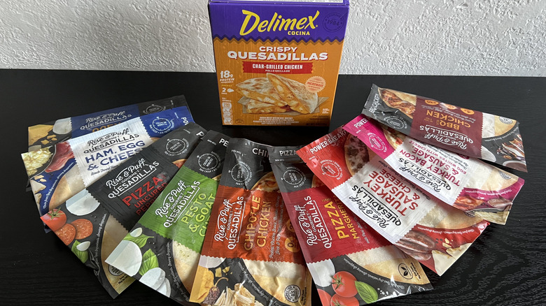Various frozen quesadillas arranged on black table