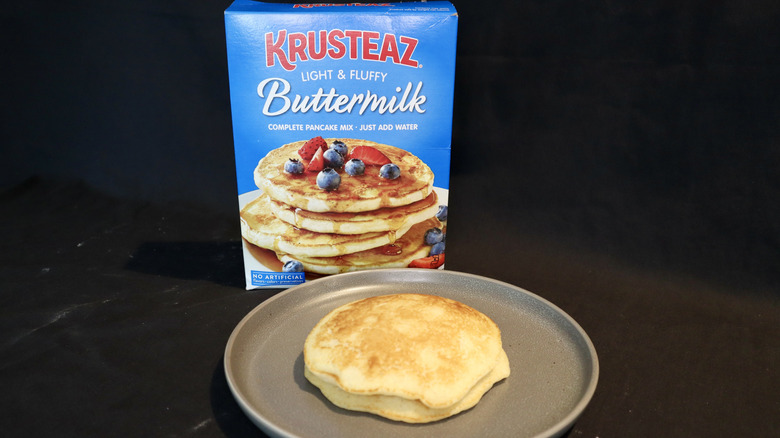 pancake on plate in front of Krusteaz box