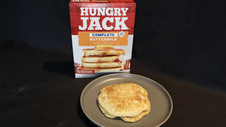 pancake on plate in front of Hungry Jack box