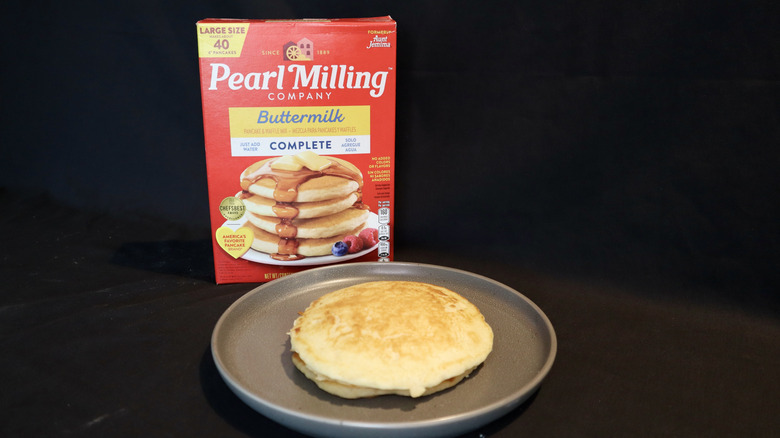 pancake on plate in front of Pearl Milling box