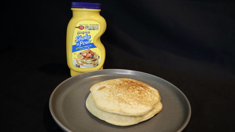 pancake on plate in front of yellow Shake 'n Pour bottle