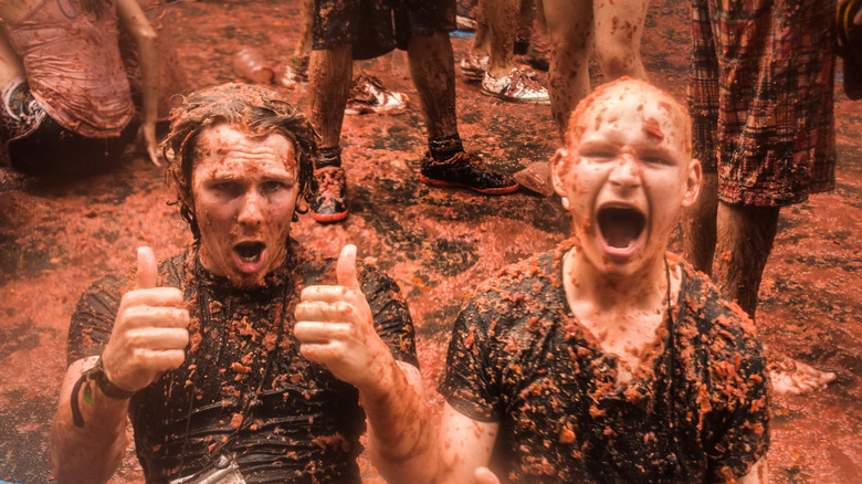 people covered in tomatoes at La Tomatina festival