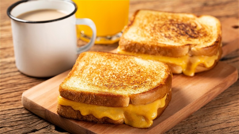 grilled cheese sandwiches on cutting board