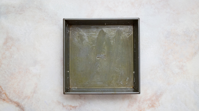 greased metal pan on table