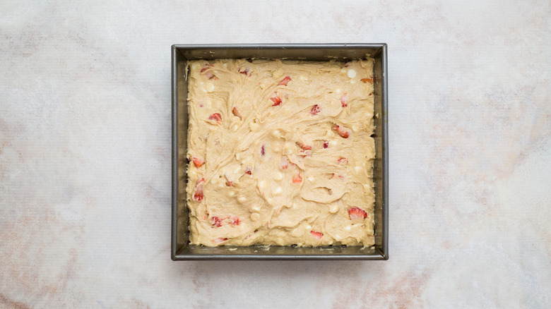strawberry blondie batter in baking pan