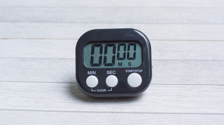 A black kitchen timer showing all zeros