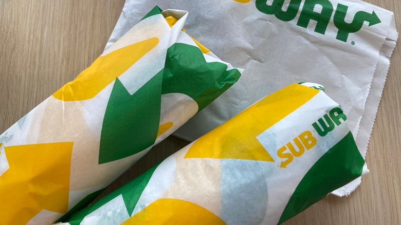 Two Subway sandwiches on table