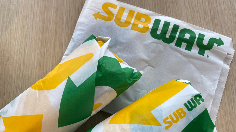 Two wrapped Subway sandwiches