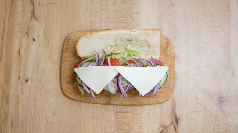 cheese hoagie on cutting board