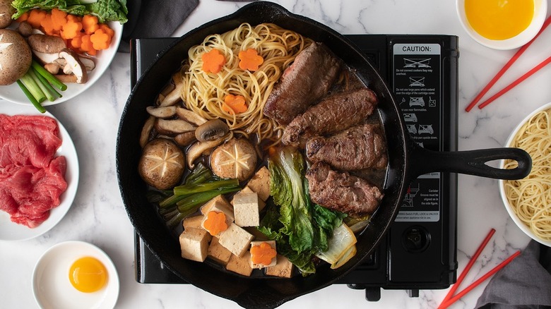 Sukiyaki: Japanese hot pot with beef, tofu, rice noodles and vegetables